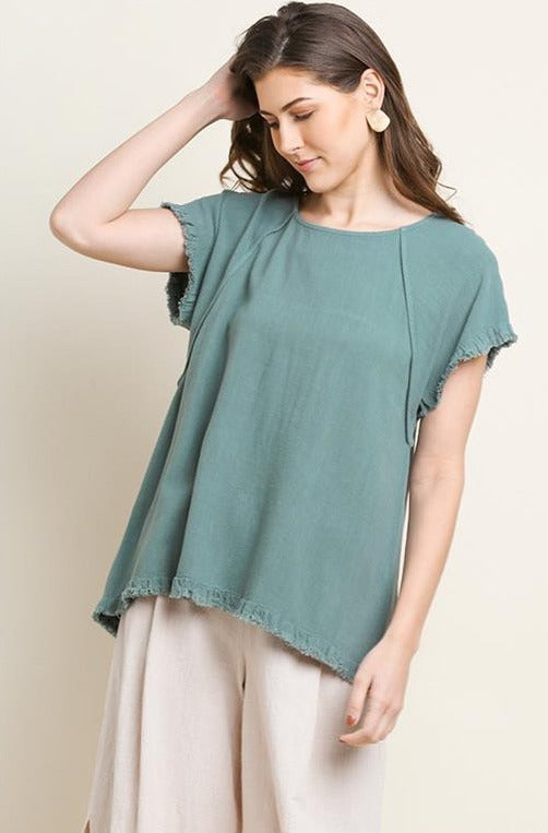 Soft and comfy women's short sleeve top featuring a round neckline. This blouse has textured hems on the bottom and sleeves for the perfect touch of flare. This women's short sleeve top will be a lovely, basic, and original addition to your wardrobe. The perfect short sleeve top to dress up or down for a variety of summertime events and occasions! Size Guide: True To Size, relaxed fit! Small - 2/4 Medium - 6/8 Large - 10/12 Fabric: 45% cotton and 55% linen