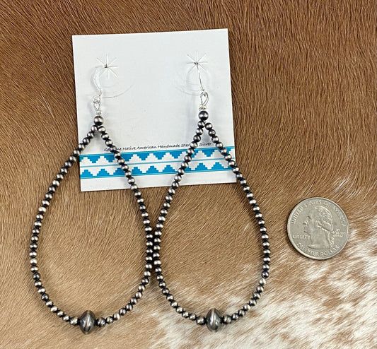 Simple lightweight and gorgeous authentic hand-strung Navajo Pearl sterling silver teardrop earrings. Hook-closure large Navajo Pearl earrings are perfect for everyday casual outfits and dressed-up ones! The perfect simple Navajo Pearl earrings also can be statement earrings. Size: 4" inches length earrings Stone: Navajo Pearls
