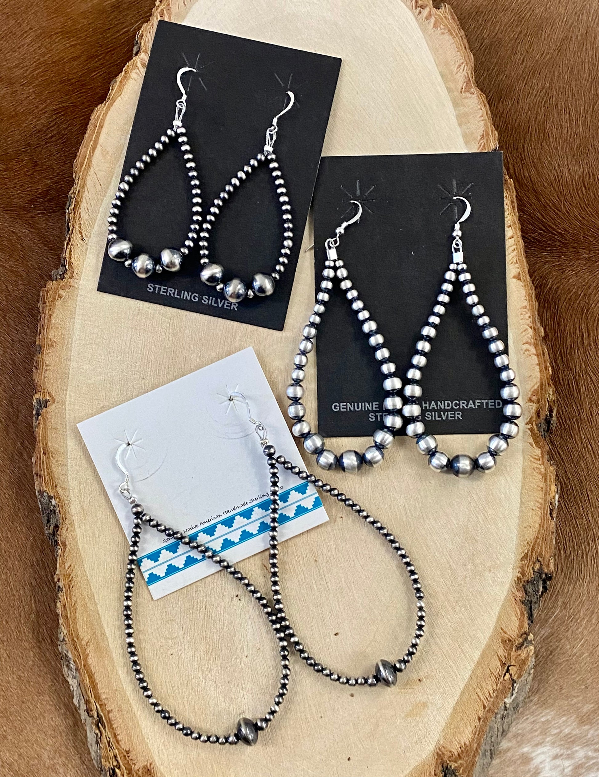 Beautiful and comfortable hand-strung Navajo pearl earrings made of sterling silver. Navajo pearl earrings with a hook closure look well with formal as well as informal outfits. The ideal Navajo pearl earrings are simple yet stylish at the same time. The perfect earrings to add to your collection of jewelry or give as a gift to someone you really care about. Each silver component is soldered shut for stability and peace of mind.  Size: 2 3/4" inches length earrings  Stone: Navajo Pearls