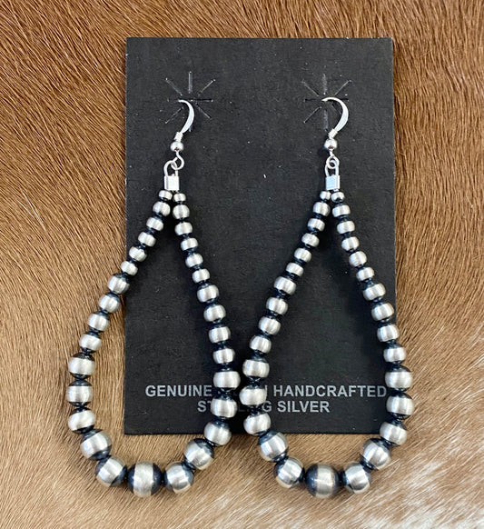 Hand-strung sterling silver Navajo pearl earrings that are easy to wear and incredibly beautiful. Earrings composed of Navajo pearls and secured by a hook go nicely with a formal or casual outfit. The perfect Navajo pearl earrings may be both simple and fashionable. The ideal earrings to add to your jewelry collection or give as a present to someone you love deeply. To provide sturdiness and peace of mind, each silver component is soldered shut. Size: 3.5" inches length earrings Stone: Navajo Pearls