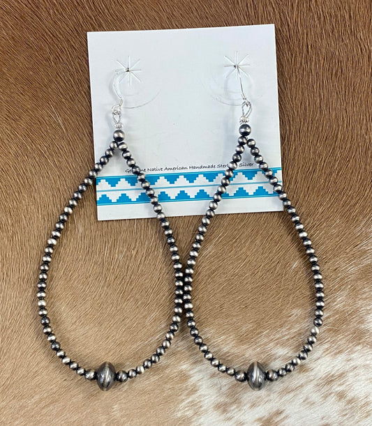Simple lightweight and gorgeous authentic hand-strung Navajo Pearl sterling silver teardrop earrings. Hook-closure large Navajo Pearl earrings are perfect for everyday casual outfits and dressed-up ones! The perfect simple Navajo Pearl earrings also can be statement earrings. Size: 4" inches length earrings Stone: Navajo Pearls