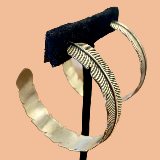 The Feather Indians Silver Earrings Stunning and unique sterling silver large feather post half hoop Native American handmade earrings. Very easy to dress up or down depending on the outfit! Add these beauties to you or your loved ones jewelry collection TODAY!   Size: 2” inch long