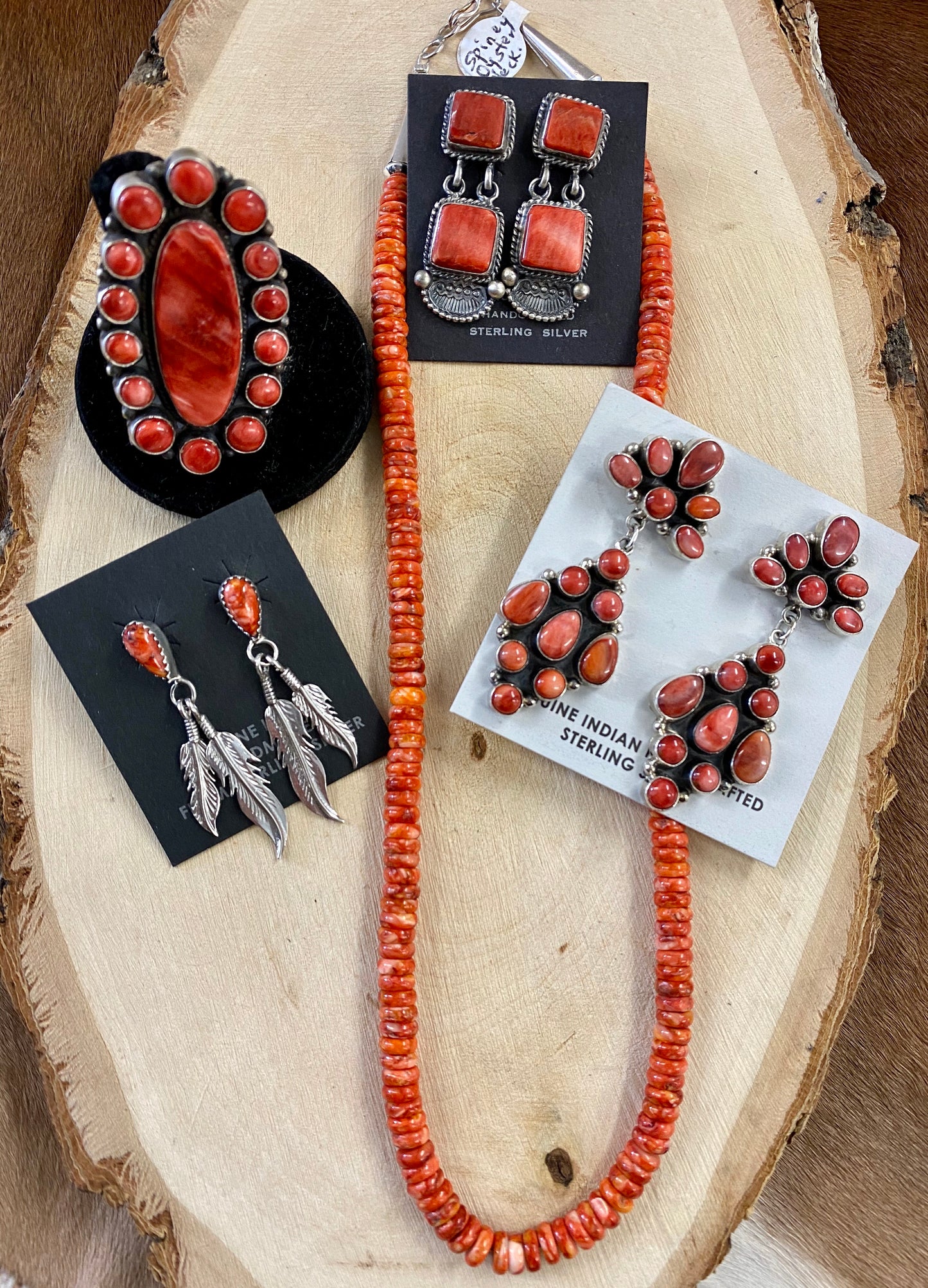 The O.A. Spiny Oyster Earrings - Ny Texas Style Boutique Red orange Spiny Oyster post sterling silver earrings. Stamped sterling and signed by Native American artist silversmith Oscar Alexius on the back. The perfect pop of color for any outfit! Size: 1.25” Inches Length Stone: Spiny Oyster Singed: YES "O.A." Hallmark/Artist: Oscar Alexius