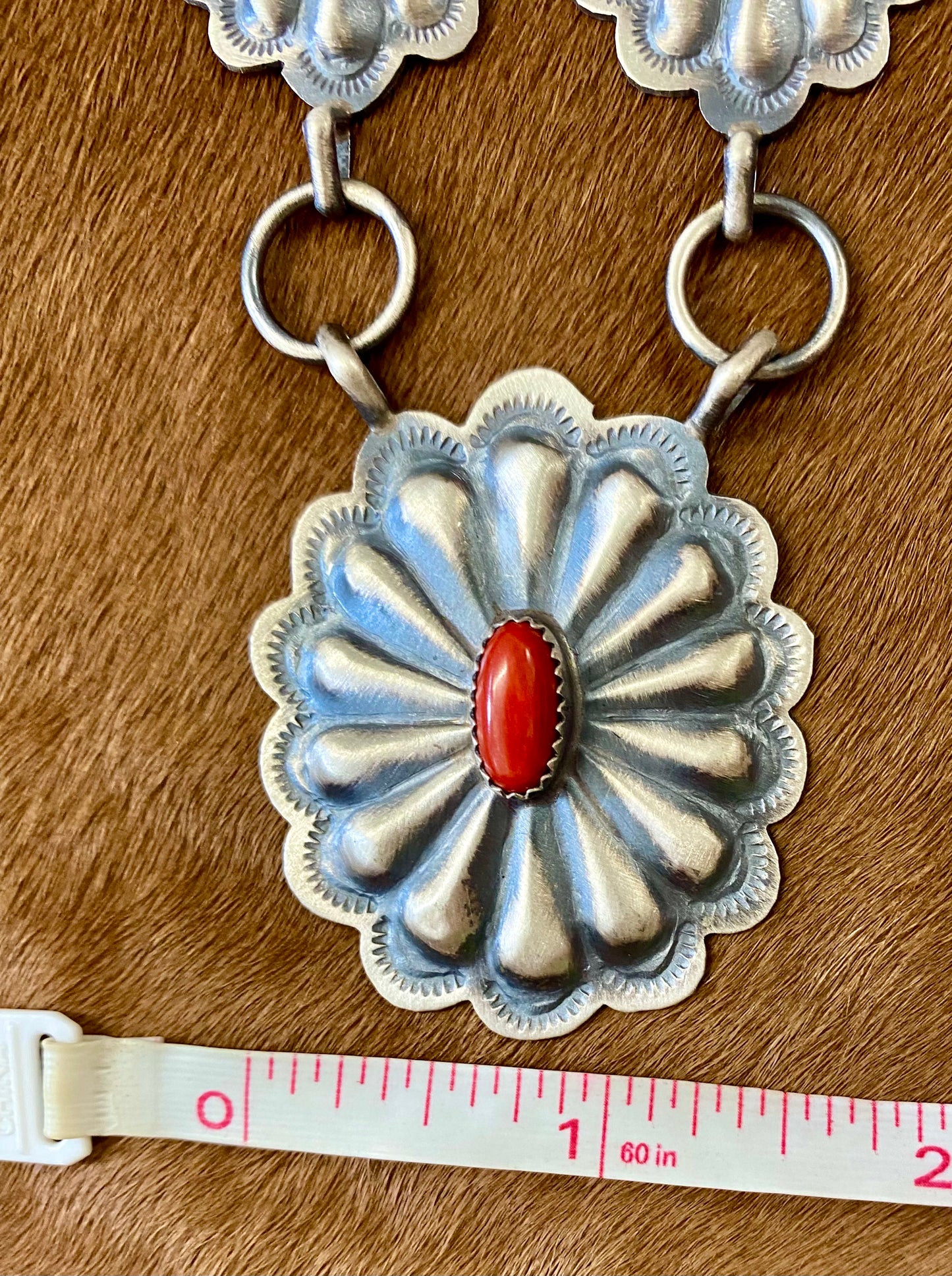 Beautiful seven silver and coral concho long 30" inch length sterling silver Native American made necklace. The piece is stamped sterling and signed "DM" on the back of the necklace. Size: 30" Inches length Stone: Coral Signed: YES "DM" Handmade Concho Coral Sterling Silver Native American Made Necklace