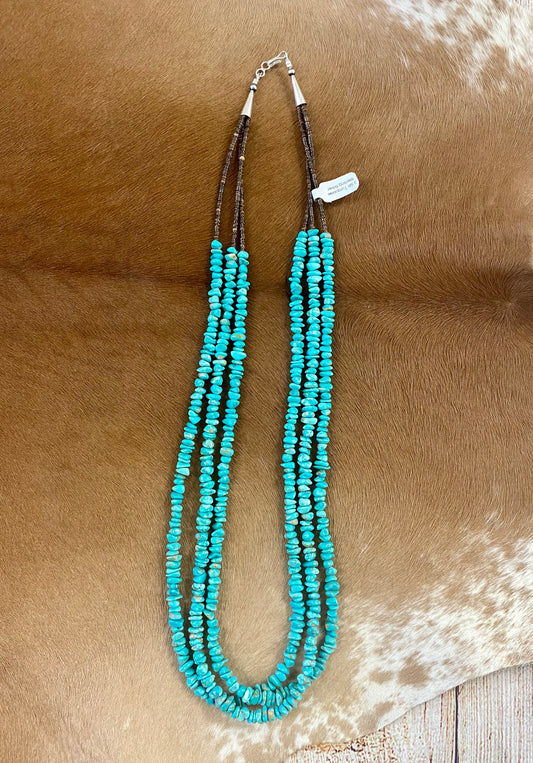 This handmade 25” inches long length necklace is an absolute beauty. A stunning three-strand turquoise beaded necklace with brown heishi beads. Layer it or wear it alone or add a pendant to keep your look totally unique. The perfect dainty layering piece! Simple, yet striking! Size: 25” Inches Length Stone: Turquoise