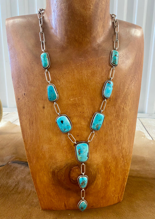 Stunning Morenci turquoise lariat style sterling silver Native American-made statement 31" inches length necklace. The perfect necklace to gift to your loved one or keep for your own jewelry collection! This piece is stamped sterling and signed "K" by the talented Native artist Karlene Goodluck. Size: 31” inches in length Stone: Morenci Turquoise Signed: YES "K" Artist / Hallmark: Karlene Goodluck