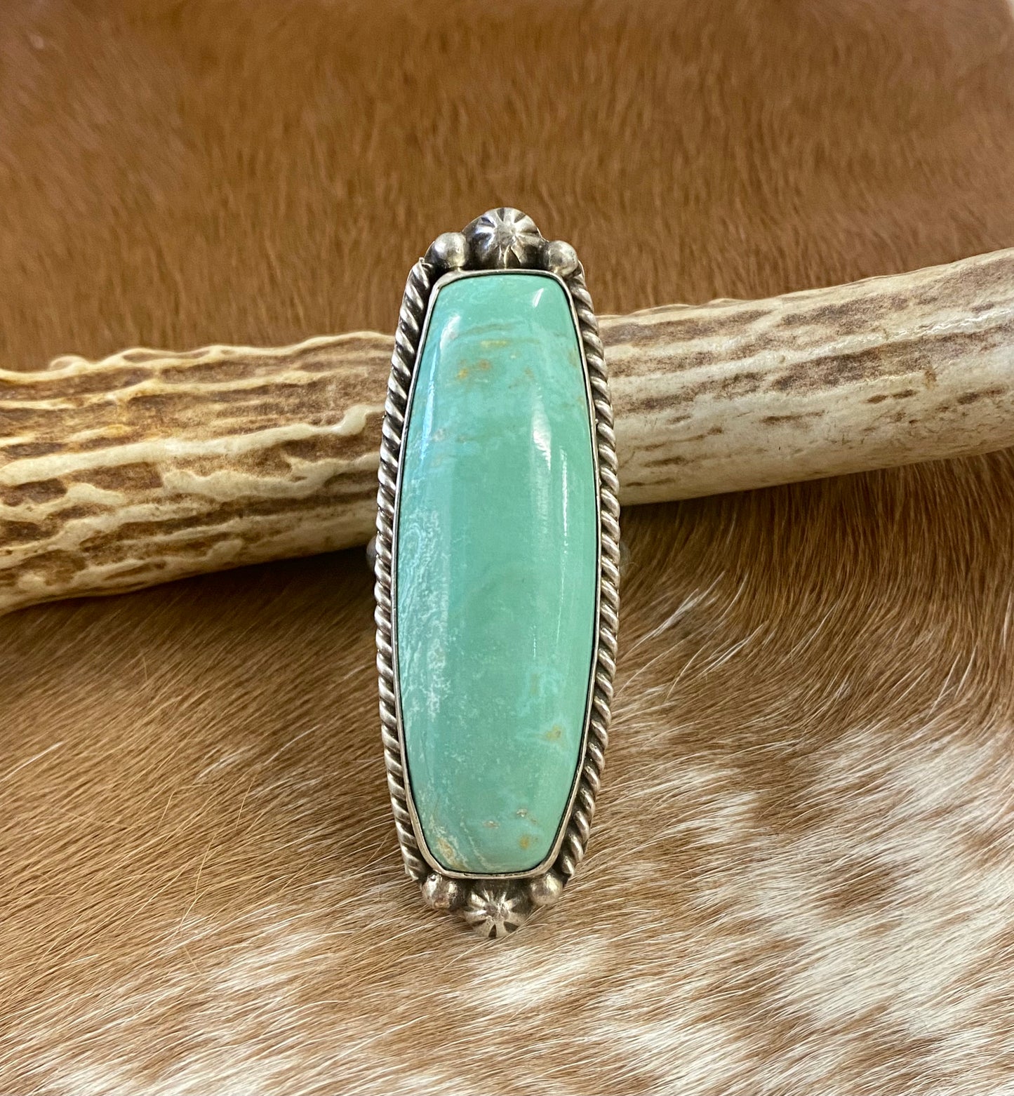 Sterling silver Tyrone Turquoise large statement single stone turquoise handmade unique size 9 ring. This piece is stamped STERLING and signed AL by an artist silversmith on the back of the ring. This ring is the perfect piece to add to anyone's jewelry collection! Size: Length 2 1/4” x 1” inches width Ring Size: 9 Signed: YES "AL" Stone: Tyrone Turquoise