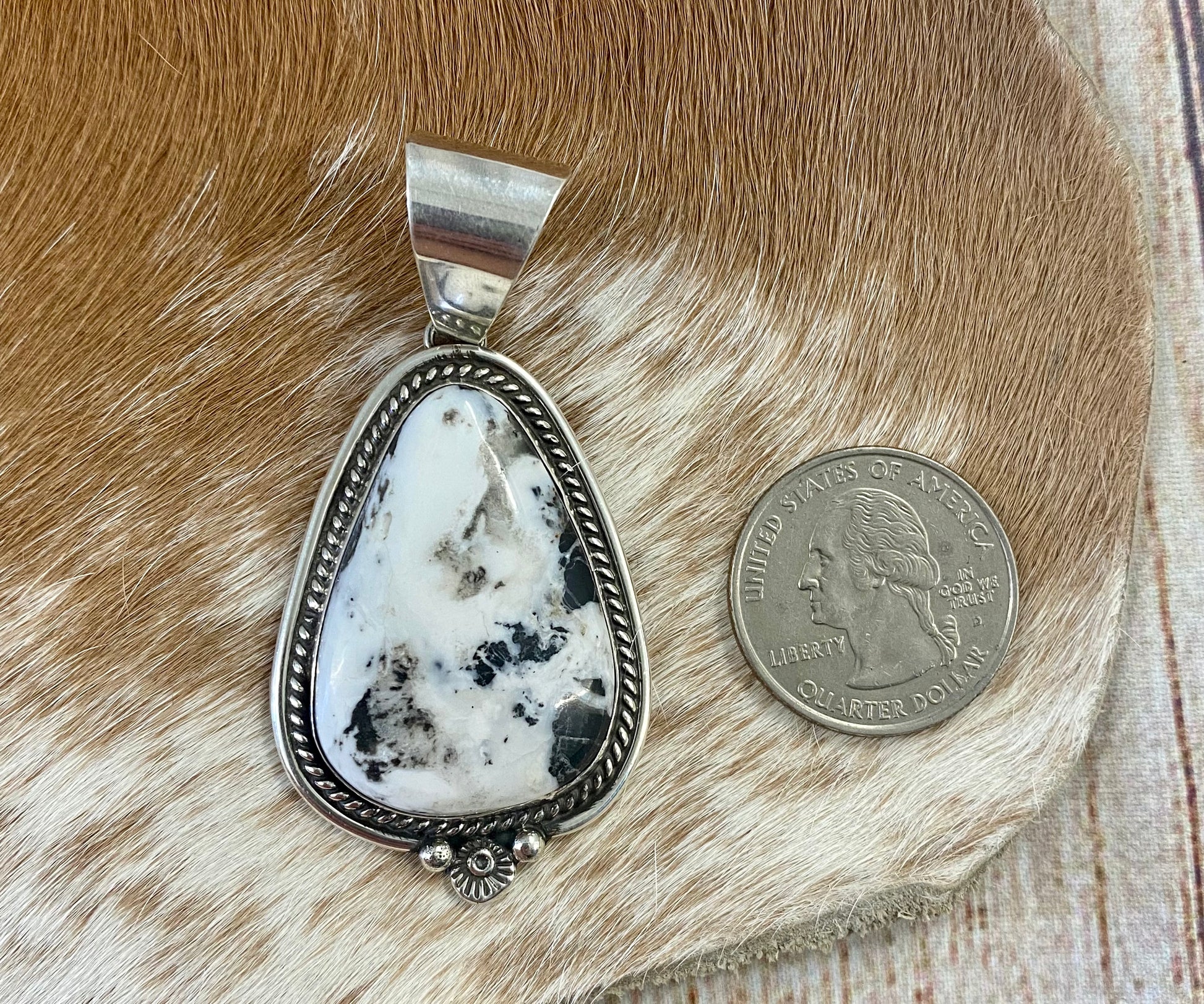 The perfect single-stone sterling silver unique Native American-made large White Buffalo pendant to add to any necklace. This piece will look gorgeous on a strand of Navajo pearls or a chain necklace. Stamped sterling and signed C Charley by Native artist silversmith. The perfect piece to add to your next outfit!   Size: 1 3/4” inches in length without bale, bale 1/2” inch. 1 1/4" inches in width   Signed: YES "C. Charley"   Hallmark/ Artist: C. Charley Stone: White Buffalo