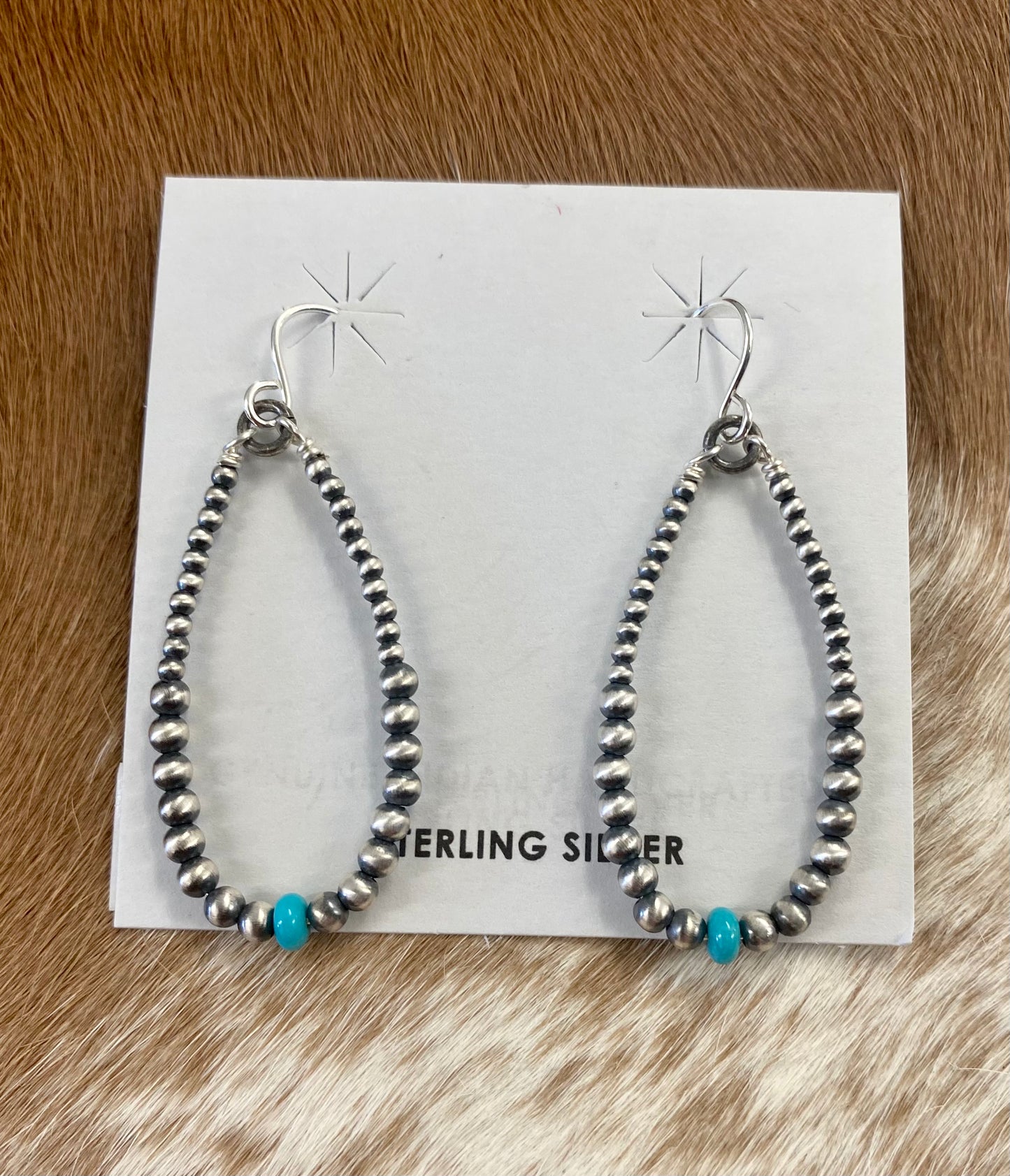 Simple lightweight and gorgeous authentic hand-strung Navajo Pearl sterling silver teardrop earrings with a turquoise stone on the bottom of each earring. Hook-closure earrings are perfect for everyday casual outfits and dressed-up ones.   Size: 1.5" inches length earrings.  Stone: Navajo Pearl & Turquoise