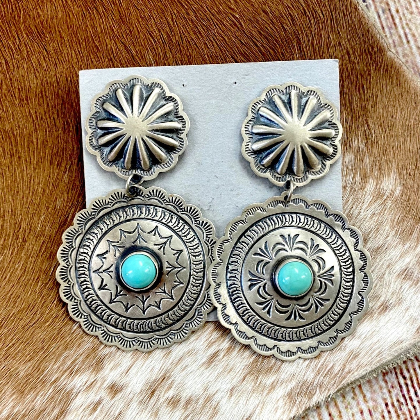 The Harris Joe Concho Turquoise Earrings - Ny Texas Style Boutique Sterling silver double Concho beautiful silver stamped earrings with turquoise stones in the center. Post large statement piece earrings that are stamped sterling and signed Harris Joe by Native American artist silversmith Harris Joe. These earrings will make a statement when paired with any outfit.