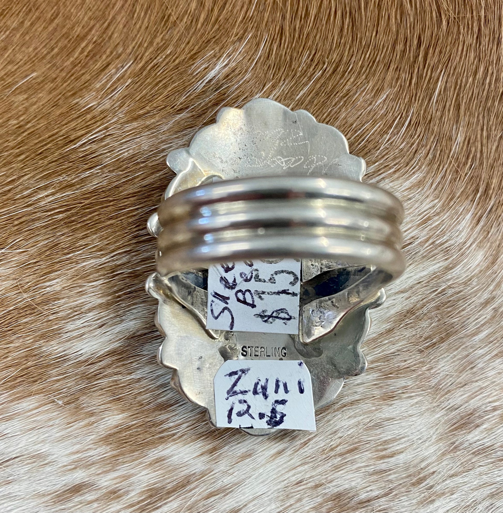 Sleeping Beauty turquoise traditional cluster sterling silver ring. Stamped sterling and signed on the back by a Zuni Native American artist silversmith. Available in size 12 1/2. The perfect piece to add to your accessory wardrobe and jewelry collection.   Size: 1.5 Inches Length X 1” Inch Width    Stone: Sleeping Beauty Turquoise   Signed: YES