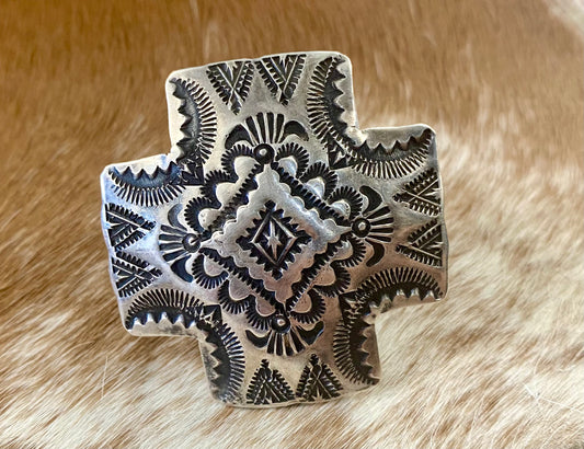Large native made sterling silver cross adjustable ring statement piece. Adjustable to fit your ring size by pushing inward on the adjustable band. Stamped sterling and signed “VJP” by Native American artist and silversmith Vincent J. Platero. This sterling silver ring is unique and will make for a beautiful addition to anyones jewelry wardrobe. Size: 1.5” Inch Length X 1.5” Inch Width Signed: YES "VJP" Hallmark/Artist: Vincent J. Platero