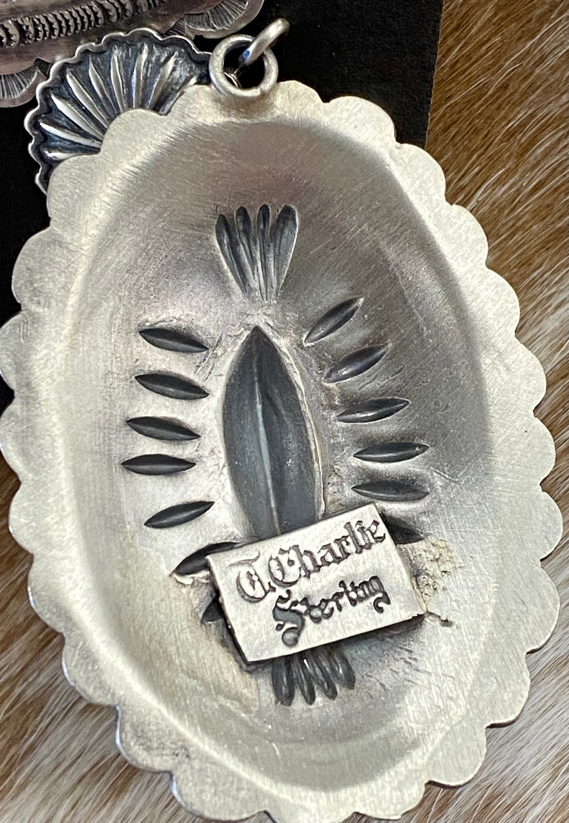 Stunning large statement Concho post sterling silver Native American made signed earrings.  The perfect earrings to add to anyone's jewelry collection. The stamping adds a unique and elegant look. Handmade by Native American artist silversmith D Tom Charlie.   Size: 2” inch length   Signed: YES  Hallmark/Artist: D Tom CharlieThe Creager Silver Concho Earrings By D Tom Charlie