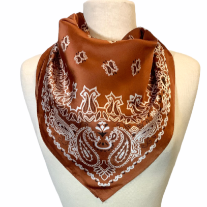 Rust orange floral paisley print silky fabric square shape scarf. Made with 100% Polyester, this will make for a beautiful addition to anyone's accessory wardrobe. Material: 100% Polyester Size: 27.5" x 27.5" The Harrington Rust Paisley Scarf - Polyester Wild Rag Bandana Print Scarf - Festival Accessories