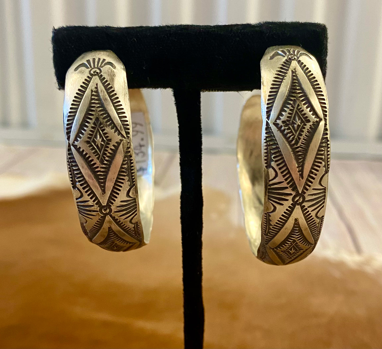 Stunning large statement Native American made sterling silver half hoop post stamped silver earrings. These are sure to make a statement when being worn with any outfit. They are so simple yet elegant. The perfect addition to anyone's jewelry collection! Size: 2” inch length Native American Handmade Stamped Silver Post Half Hoop Unique Earrings