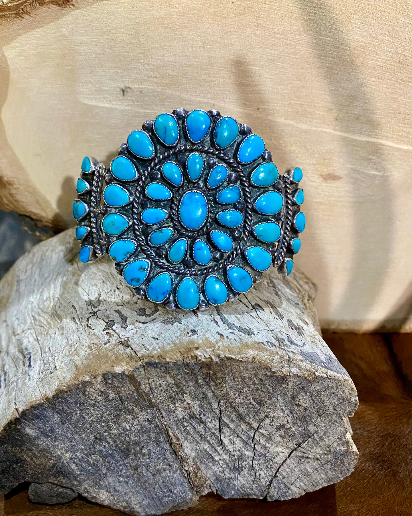 Immaculate turquoise sterling silver cluster cuff. 6” inch length inside measurements plus 1.25” inch gap. Center stone area is 2.25” inch length. Beautiful turquoise cluster cuff, the perfect addition to anyone's jewelry collection. The perfect statement piece to add to any outfit.