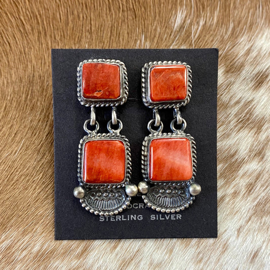 The O.A. Spiny Oyster Earrings - Ny Texas Style Boutique Sterling Silver Spiny Oyster Post Native American Made By Oscar AlexiusRed orange Spiny Oyster post sterling silver earrings. Stamped sterling and signed by Native American artist silversmith Oscar Alexius on the back. The perfect pop of color for any outfit! Size: 1.25” Inches Length Stone: Spiny Oyster Singed: YES "O.A." Hallmark/Artist: Oscar Alexius