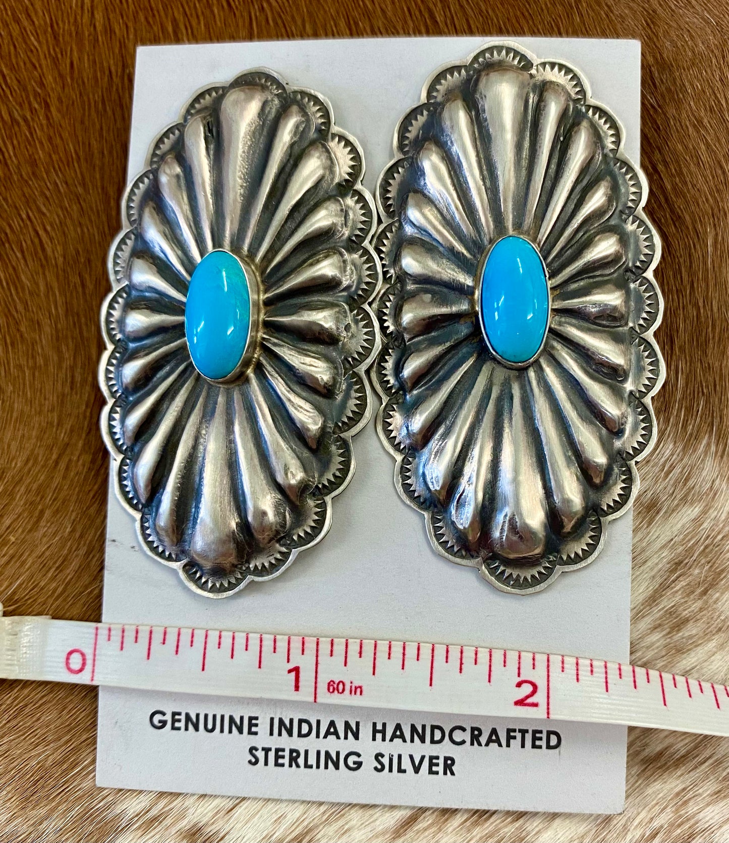 Beautiful large statement Concho sterling silver sleeping beauty turquoise earrings with single stone pieces of turquoise in the center. Stamped sterling and signed by Native American artist silversmith Rita Lee. The perfect set of earrings to add in to anyone's jewelry collection. Dress them up or down! Size: 2 1/2" Inches Long x 1 1/4" Inches Wide Hallmark/Artist: Rita Lee Stone: Turquoise