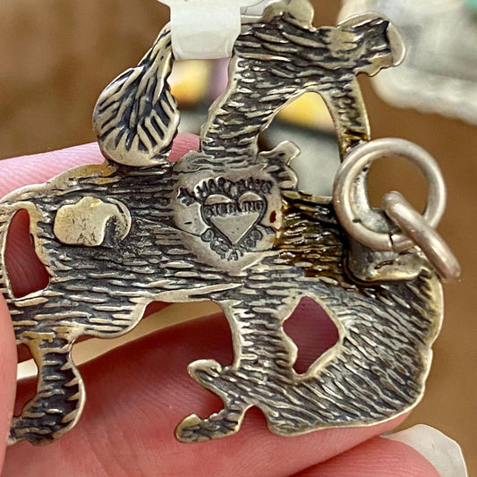 Bucking bronco cowboy sterling silver pendant/charm. The perfect addition to anyone's jewelry collection. This piece is stamped, please see photos below for hallmark. This pendant is so fun and unique. It would make for a beautiful addition to your next outfit or gift it to a loved one! Size: 1.25” Inches length Signed: Yes