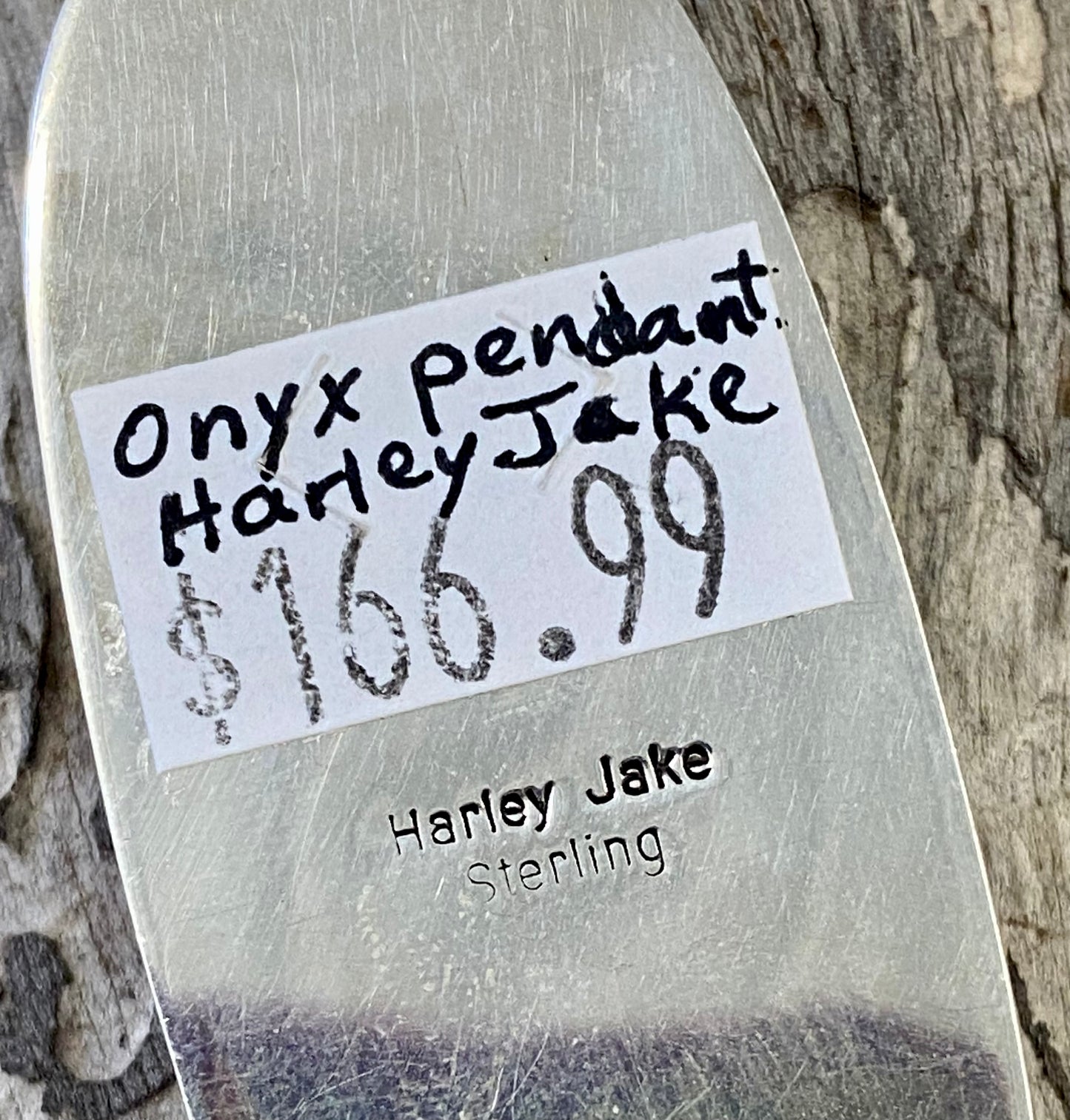 The perfect single-stone sterling silver Native American-made large black onyx pendant to add to any necklace. This piece will look gorgeous on a strand of Navajo pearls or a chain necklace. Stamped sterling and signed Harley Jake by Native artist silversmith Harley Jake on the back of the pendant. Size: 2” inch length, bale 1/2” inch. 1" inch width Signed: YES "Harley Jake" Hallmark/ Artist: Harley Jake Stone: Onyx