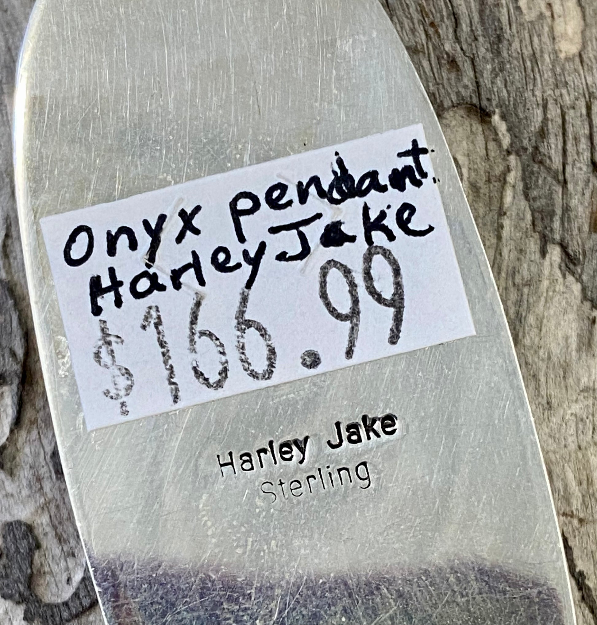 The perfect single-stone sterling silver Native American-made large black onyx pendant to add to any necklace. This piece will look gorgeous on a strand of Navajo pearls or a chain necklace. Stamped sterling and signed Harley Jake by Native artist silversmith Harley Jake on the back of the pendant.   Size: 2” inch length, bale 1/2” inch. 1" inch width   Signed: YES "Harley Jake"   Hallmark/ Artist: Harley Jake  Stone: Onyx