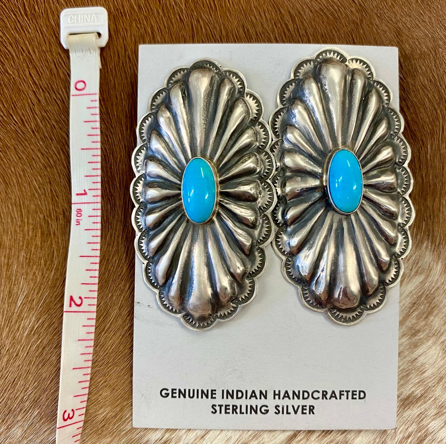 Beautiful large statement Concho sterling silver sleeping beauty turquoise earrings with single stone pieces of turquoise in the center. Stamped sterling and signed by Native American artist silversmith Rita Lee. The perfect set of earrings to add in to anyone's jewelry collection. Dress them up or down! Size: 2 1/2" Inches Long x 1 1/4" Inches Wide Hallmark/Artist: Rita Lee Stone: Turquoise