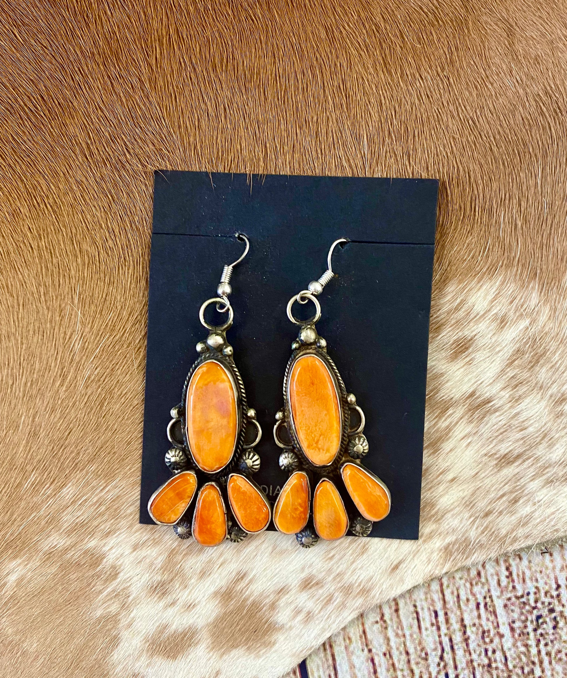 Beautiful statement spiny oyster sterling silver hook earrings. This piece is stamped sterling and signed on the back by their native artist silversmith. These will make a pop in any jewelry collection.   Size: 2" Inches length   Signed: YES  Stone: Spiny Oyster