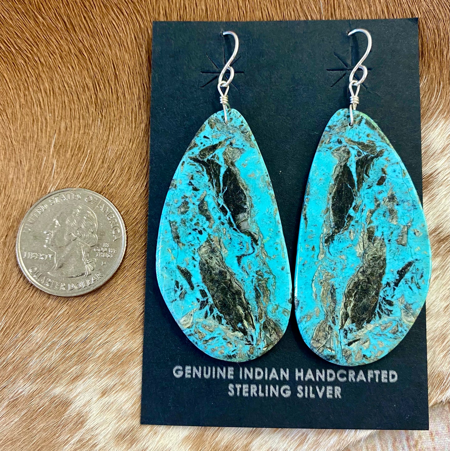 Large statement sterling silver handmade Native American made turquoise slab earrings. These are gorgeous and will make a statement with any outfit, any jewelry collection! These are made by Native American artist silversmith Ron Chavez. Size: 2” inch length Artist/Hallmark: Ron Chavez Stone: Turquoise