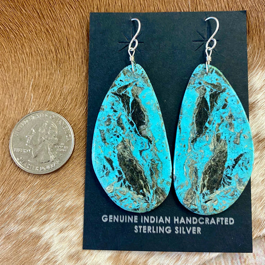 Large statement sterling silver handmade Native American made turquoise slab earrings. These are gorgeous and will make a statement with any outfit, any jewelry collection! These are made by Native American artist silversmith Ron Chavez. Size: 2” inch length Artist/Hallmark: Ron Chavez Stone: Turquoise