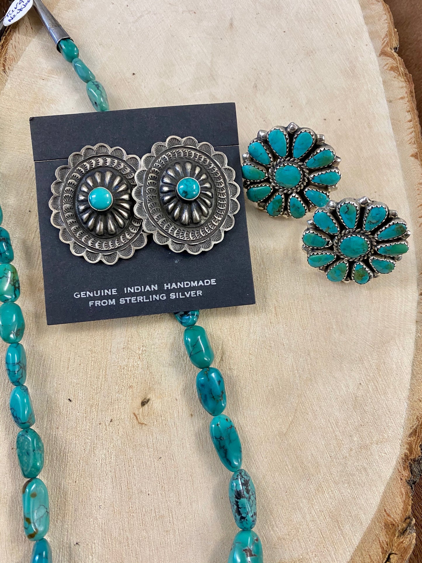 Native American Made Sterling Silver Concho Earrings With Turquoise Authentic large post concho style sterling silver earrings with turquoise. Stamped sterling and signed by Native American artist silversmith on the back inside the indent of the earrings.