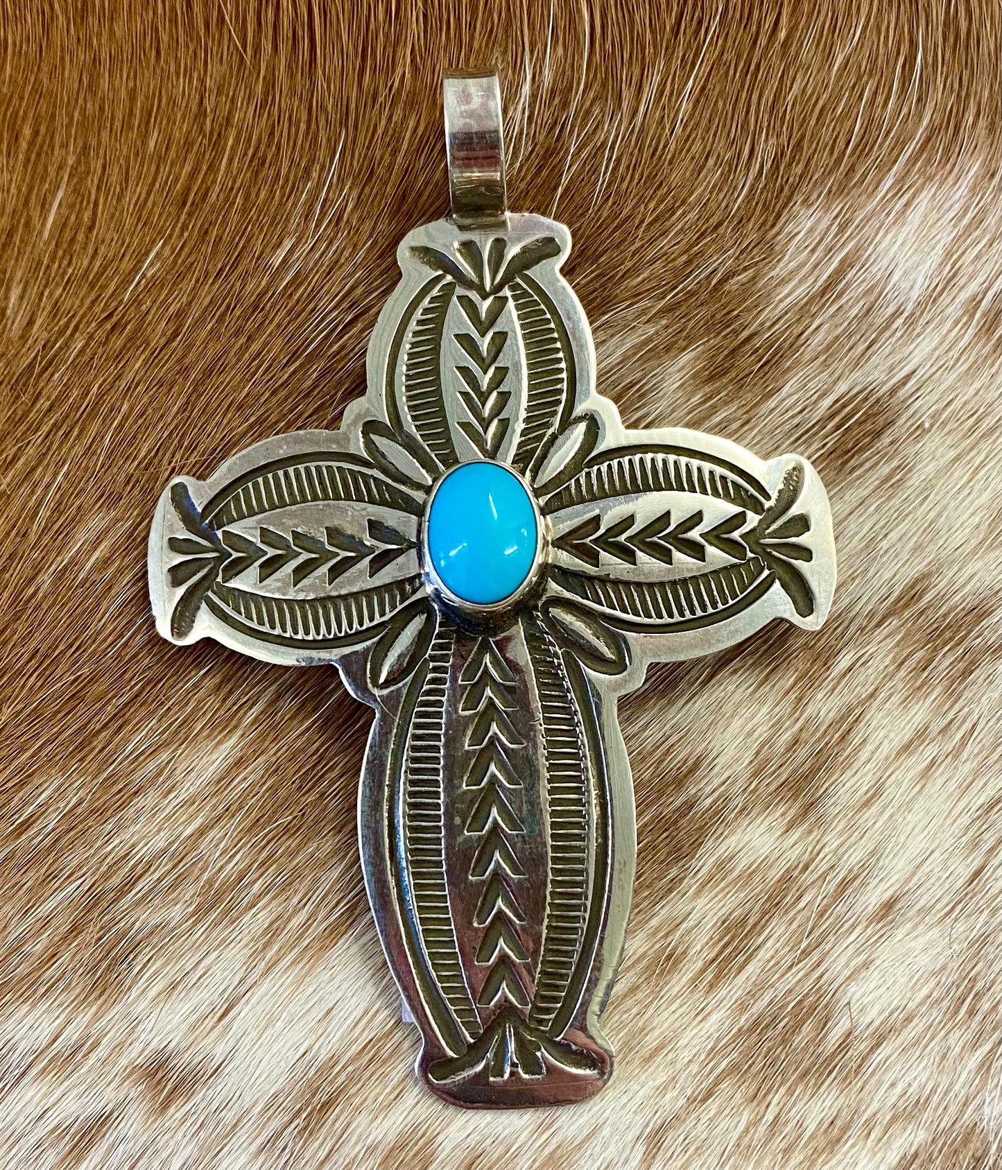 Beautiful sterling silver Native made turquoise cross pendant. Stamped sterling and signed BLKGT by Native American artist silversmith Arnold Blackgoat. The perfect cross to wear on any length chain necklace or a very small 3mm Navajo pearl necklace. Size: 2” inches length x 1.5” inches width Signed: YES "BLKGT" Hallmark/Artist: Arnold Blackgoat Stone: Turquoise