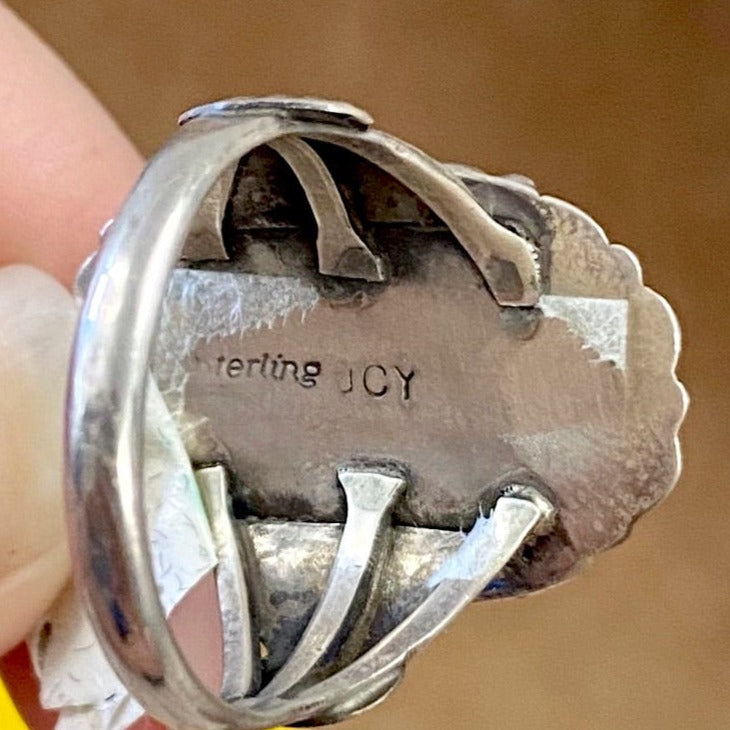 The Moonlite Ring - Ny Texas Style Boutique Vintage turquoise ring detail on band size 10.5 stamped sterling and signed JCY on back. This beauty is Native made and will make for a beautiful statement piece in your jewelry collection. Size: 1” Inch length Ring Size: 10.5 Stone: Turquoise Signed: YES "JCY"