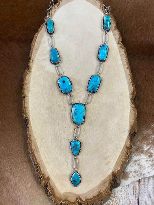 Stunning Morenci turquoise lariat style sterling silver Native American-made statement 31" inches length necklace. The perfect necklace to gift to your loved one or keep for your own jewelry collection! This piece is stamped sterling and signed "K" by the talented Native artist Karlene Goodluck. Size: 31” inches in length Stone: Morenci Turquoise Signed: YES "K" Artist / Hallmark: Karlene Goodluck