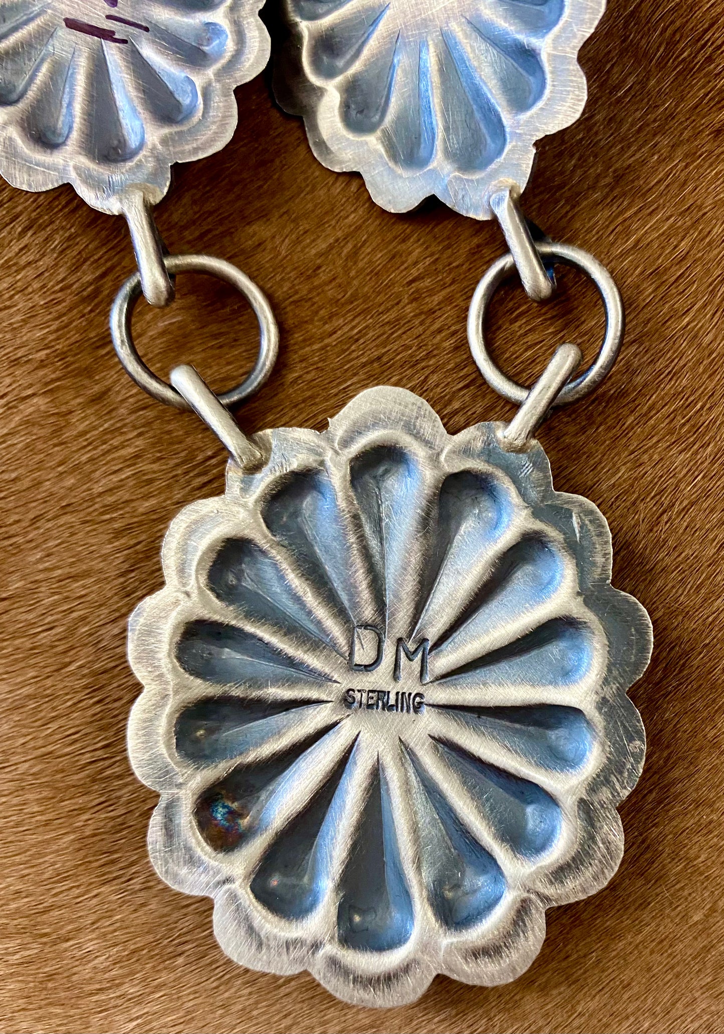 Beautiful seven silver and coral concho long 30" inch length sterling silver Native American made necklace. The piece is stamped sterling and signed "DM" on the back of the necklace. Size: 30" Inches length Stone: Coral Signed: YES "DM" Handmade Concho Coral Sterling Silver Native American Made Necklace