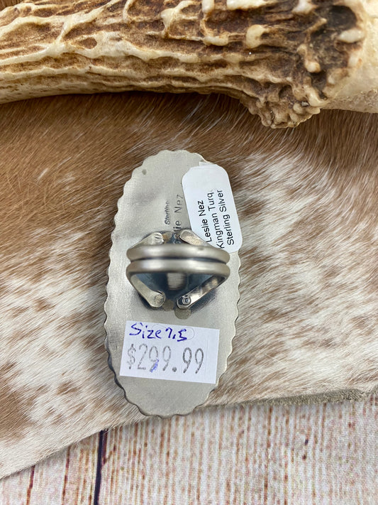 Kingman turquoise single-stone sterling silver large ring. Stamped sterling and signed "Leslie Nez” on the back by Native American artist silversmith Leslie Nez. Available in size 7.5. The perfect piece to add to your accessory wardrobe and jewelry collection.   Size: 2.5 Inches Length X 1 1/4” Inch Width    Stone: Kingman Turquoise   Signed: YES “Leslie Nez”   Hallmark: Leslie Nez