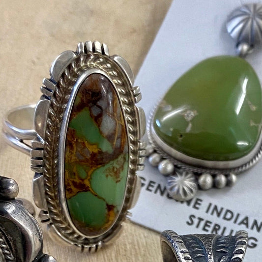 The Ramblin’ Green Turquoise Ring (Size 9.5) - Ny Texas Style Boutique Sterling silver single stone green turquoise stamped sterling and signed inside of the ring band ring. This particular size 9.5 ring is absolutely stunning. The color variation throughout the piece is truly unique. Size: 1.25" Inches Length Ring Size: 9.5 Signed: YES "NJ" Stone: TurquoiseGreen Turquoise With Brown Matrix Ring Size 9.5 | Native American Made