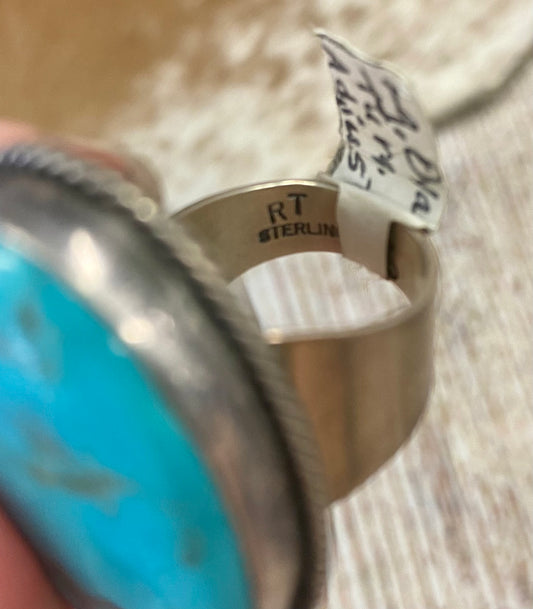 Sterling Silver Turquoise Adjustable Ring By Navajo Artist Ray Tafoya Large 1.5” inches length turquoise single stone sterling silver adjustable ring. Stamped sterling and signed “RT” inside of the ring band by Native American artist silversmith Ray Tafoya. Stunning unique statement turquoise large single stone piece. The perfect addition to add to your next look. Size: 1.5” Inches Length Adjustable Size Hallmark/Artist: Ray Tafoya Signed: YES "RT"