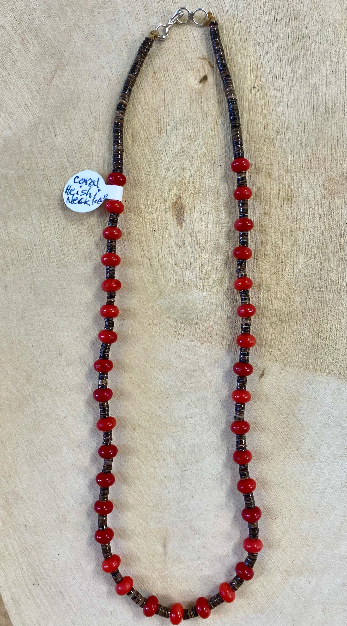 Red coral and brown heishi single strand choker length sterling silver native strung necklace. The perfect piece to layer with other necklaces or wear alone. Mix and match with other stone jewelry or stay with coral! Size: 14" Inches Stone: Coral