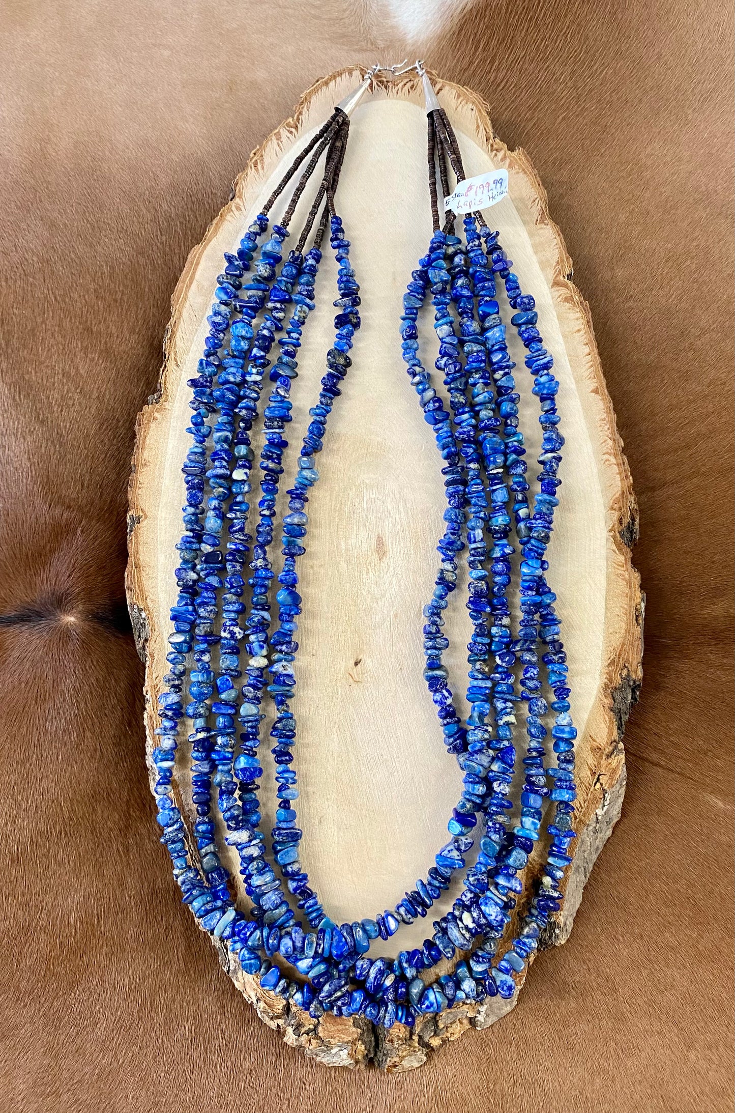 Absolutely stunning sterling silver clasp five strand hand strung blue Lapis and heishe 27” inch length necklace. The shades of blue in this piece are out of this world amazing! This necklace will make a statement with any outfit. Size: 27" Inches Length Stone: Blue Lapis