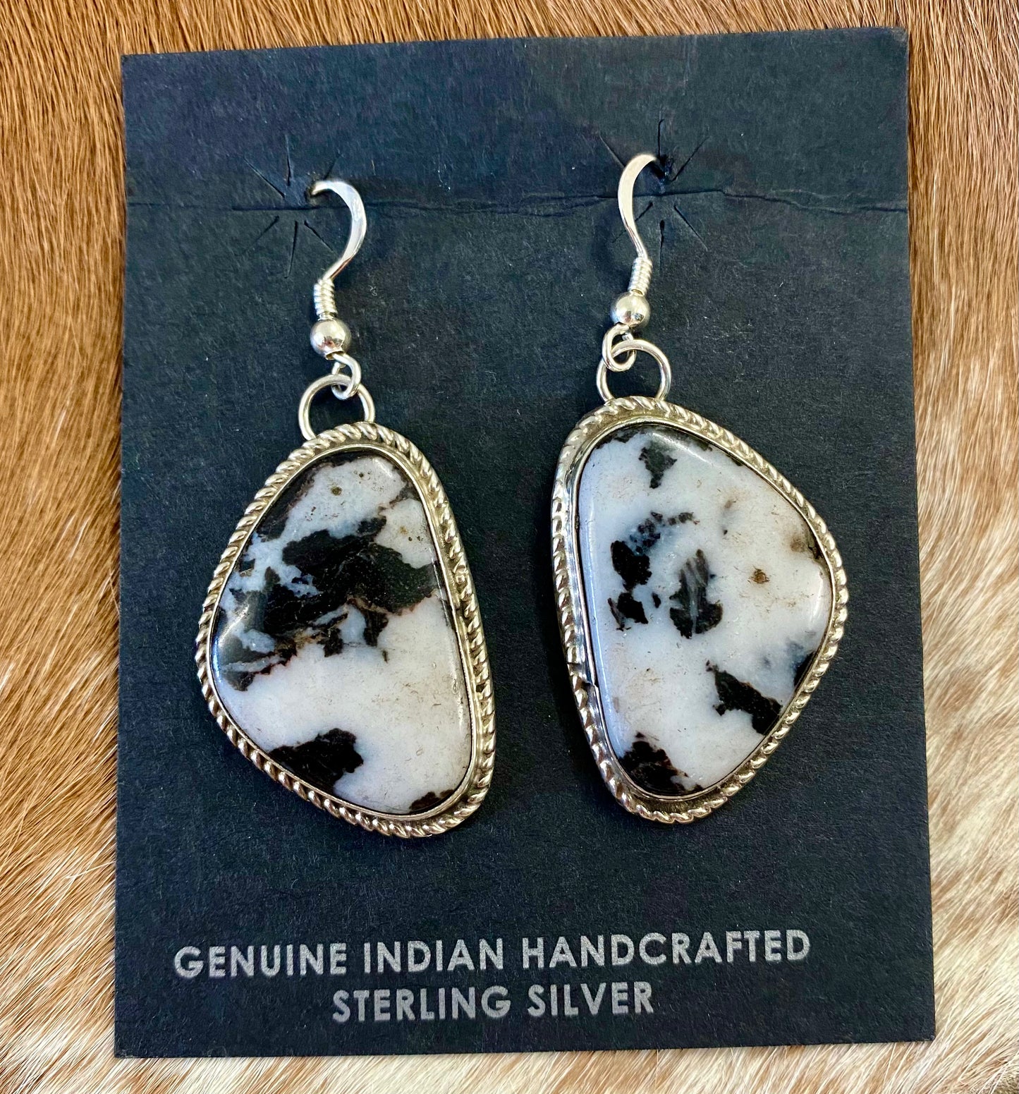 Stunning large statement hook sterling silver white buffalo native made earrings. Stamped sterling and signed by Native American artist silversmith Marcella James. These will make for a beautiful addition to anyone's jewelry collection. Size: 1.5 inches length x 1” inches width Signed: YES "MARCELLA JAMES" Hallmark/Artist: MARCELLA JAMES Stone: White Buffalo