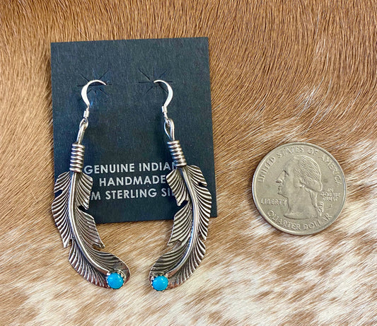 Native American Made Turquoise Feather Hook Sterling Silver Earrings Beautiful lightweight turquoise sterling silver Native American handmade feather hook earrings. These earrings are so fun and easy to pair with so many different outfits. Keep for yourself or gift to a loved one. Hallmark/Artist: Louise Joe Stone: Turquoise | Turquoise Feather Earrings, Silver Native Made Earrings