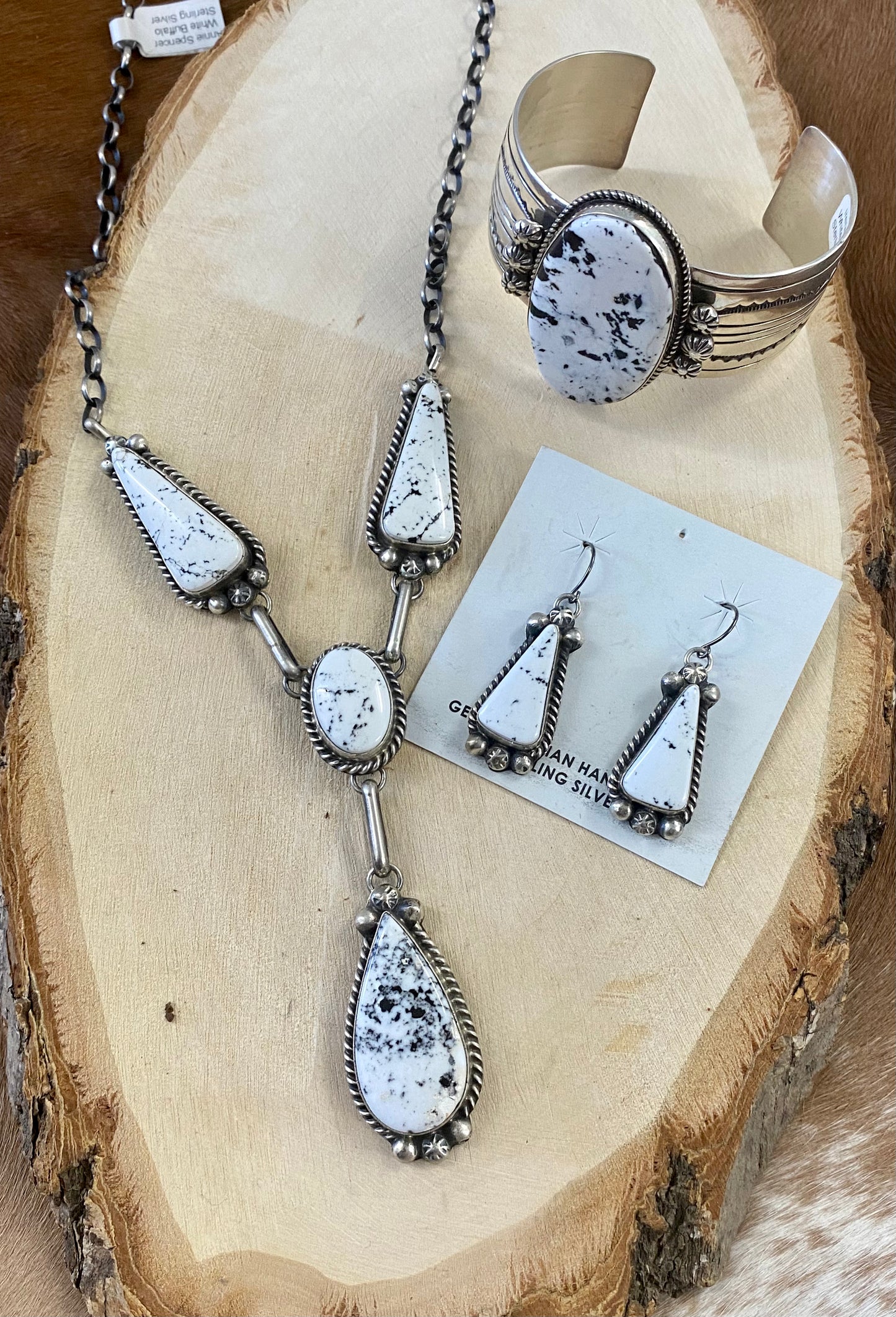 Stunning White Buffalo lariat style sterling silver Native American made necklace and drop hook matching White Buffalo sterling silver earrings set. The perfect jewelry set to gift to your loved one or keep for your own jewelry collection! Both pieces are stamped sterling and signed on the back by talented artist silversmith Annie Spencer. Size: 27” inches in length necklace + 1 1/2” inch earrings Stone: White Buffalo Signed: YES "AL" Artist / Hallmark: Annie Spencer