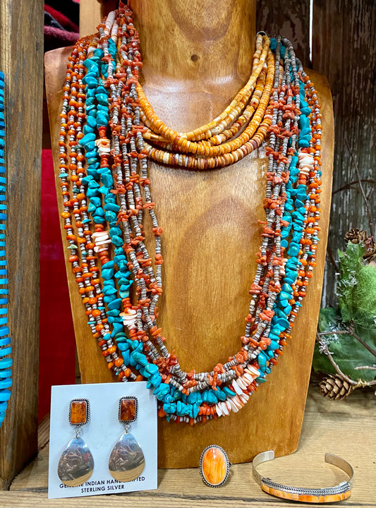 Stamped sterling orange spiny oyster post earrings with reflective mirror bottom. These spiny oyster Native American made earrings are stunning. They will make for an awesome statement piece in anyone's jewelry collection. Size: 2" Inch Length Stone: Spiny Oyster