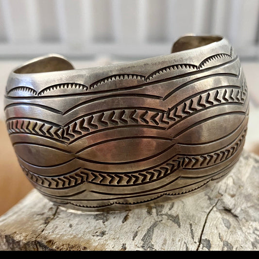The Detailed Carson B. Cuff - Ny Texas Style Boutique Native American made large stamped statement detailed silver cuff. Made of sterling silver and stamped sterling inside as well as signed by Native artist silversmith Carson Blackgoat. Absolutely gorgeous detailed cuff, that will make for a beautiful addition to anyone's jewelry collection or as a gift. Size: 1.5” Inches width 6.5” Inches all the way around not including gap Signed: YES "CARSON B" Artist/Hallmark: Carson Blackgoat