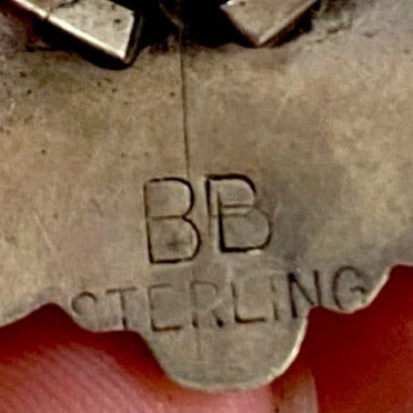 Size 9 Sterling Silver Native Made Turquoise Cluster Ring Signed BB Beautiful size 9 sterling silver native made turquoise cluster ring signed BB on the back by artist and silversmith. The perfect turquoise ring to wear daily or as a statement piece in your jewelry collection! Cluster rings are so beautiful, it's no surprise they're popular! Size: 1.25” Inch length Signed: YES "BB" Stone: Turquoise