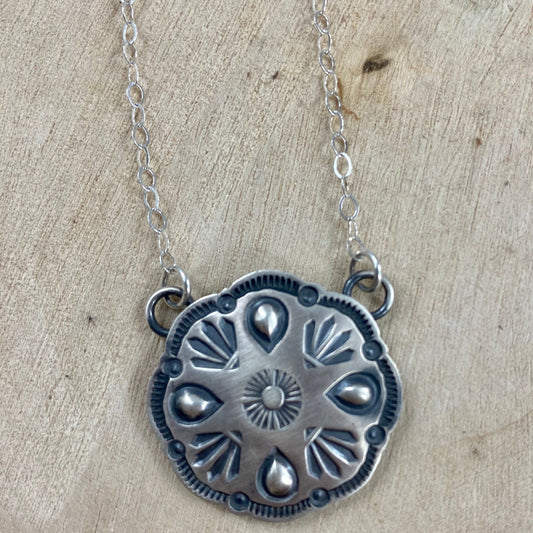 The Goodluck Navajo Concho Necklace - Ny Texas Style Boutique Concho statement Native American made pendant necklace. Stamped sterling and signed AG inside of a clover on the back of the necklace. Signed by Native artist and silversmith Arnold & Carleena Goodluck. The perfect silver statement necklace to style with all different kinds of outfits. From NFR rodeo outfits to concert or everyday outfits.