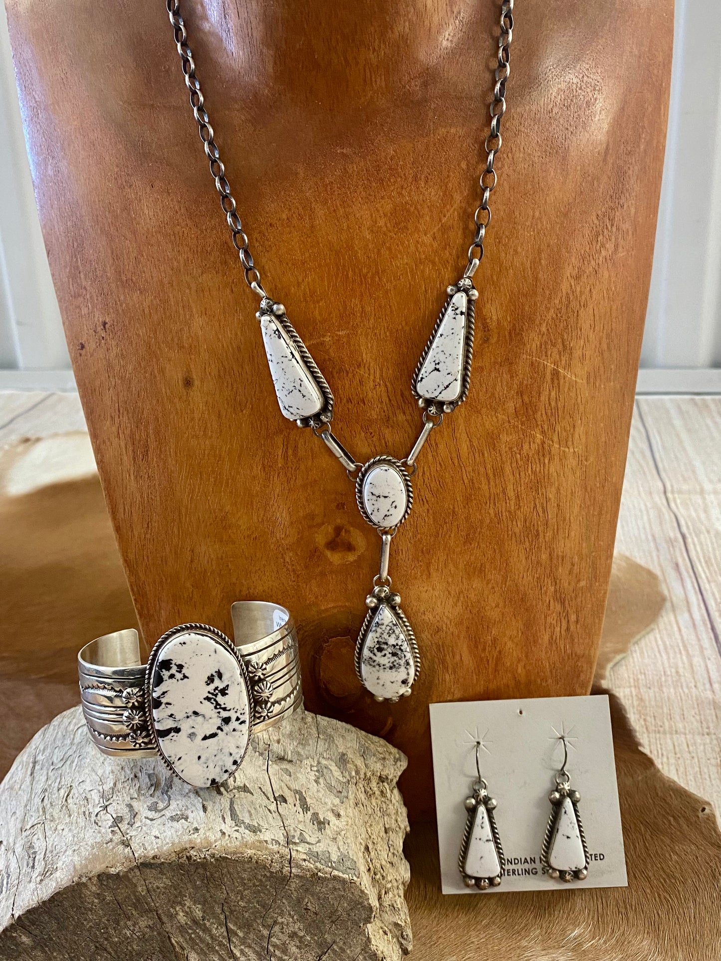 Stunning White Buffalo lariat style sterling silver Native American made necklace and drop hook matching White Buffalo sterling silver earrings set. The perfect jewelry set to gift to your loved one or keep for your own jewelry collection! Both pieces are stamped sterling and signed on the back by talented artist silversmith Annie Spencer. Size: 27” inches in length necklace + 1 1/2” inch earrings Stone: White Buffalo Signed: YES "AL" Artist / Hallmark: Annie Spencer