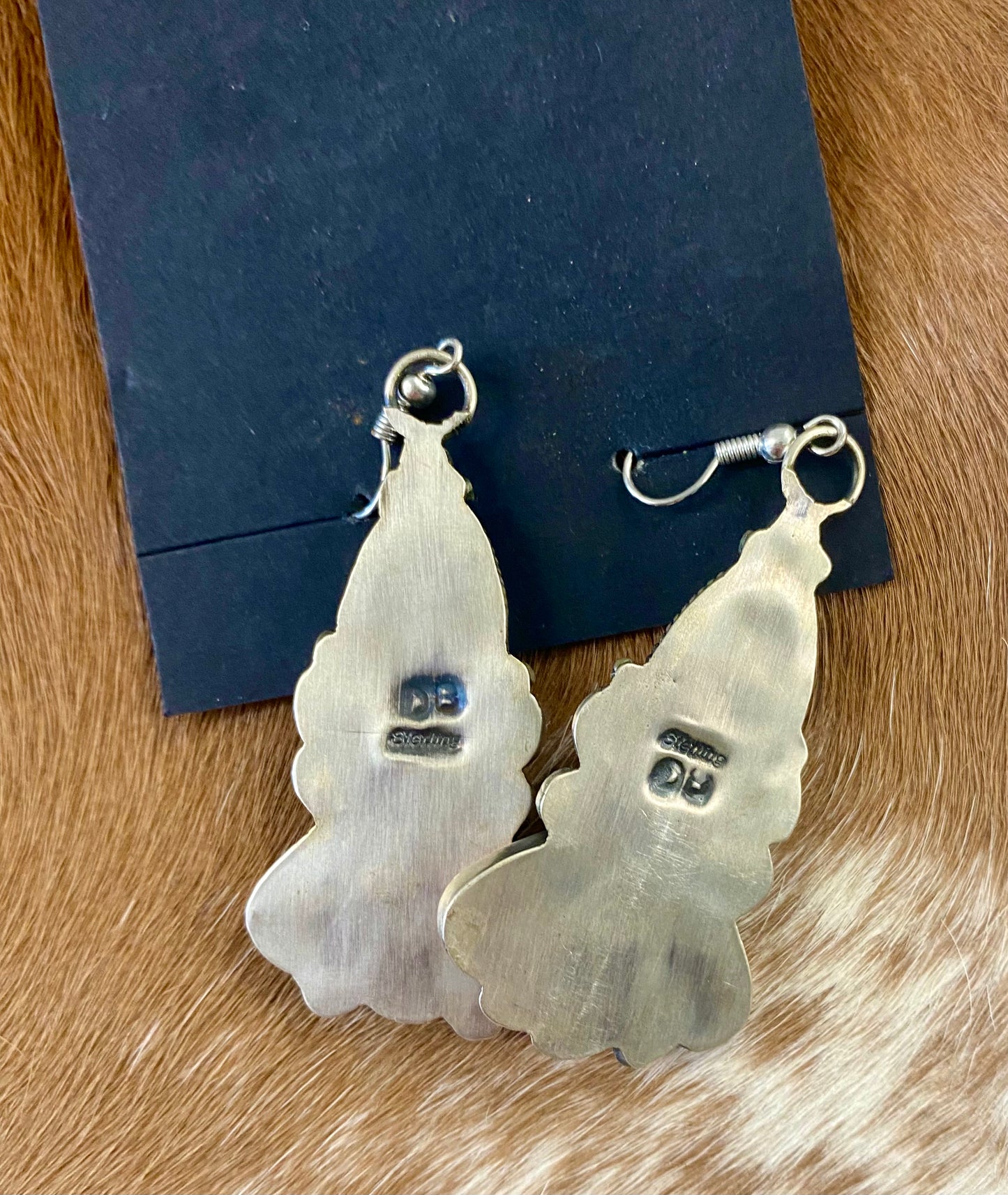 Beautiful statement spiny oyster sterling silver hook earrings. This piece is stamped sterling and signed on the back by their native artist silversmith. These will make a pop in any jewelry collection.   Size: 2" Inches length   Signed: YES  Stone: Spiny Oyster