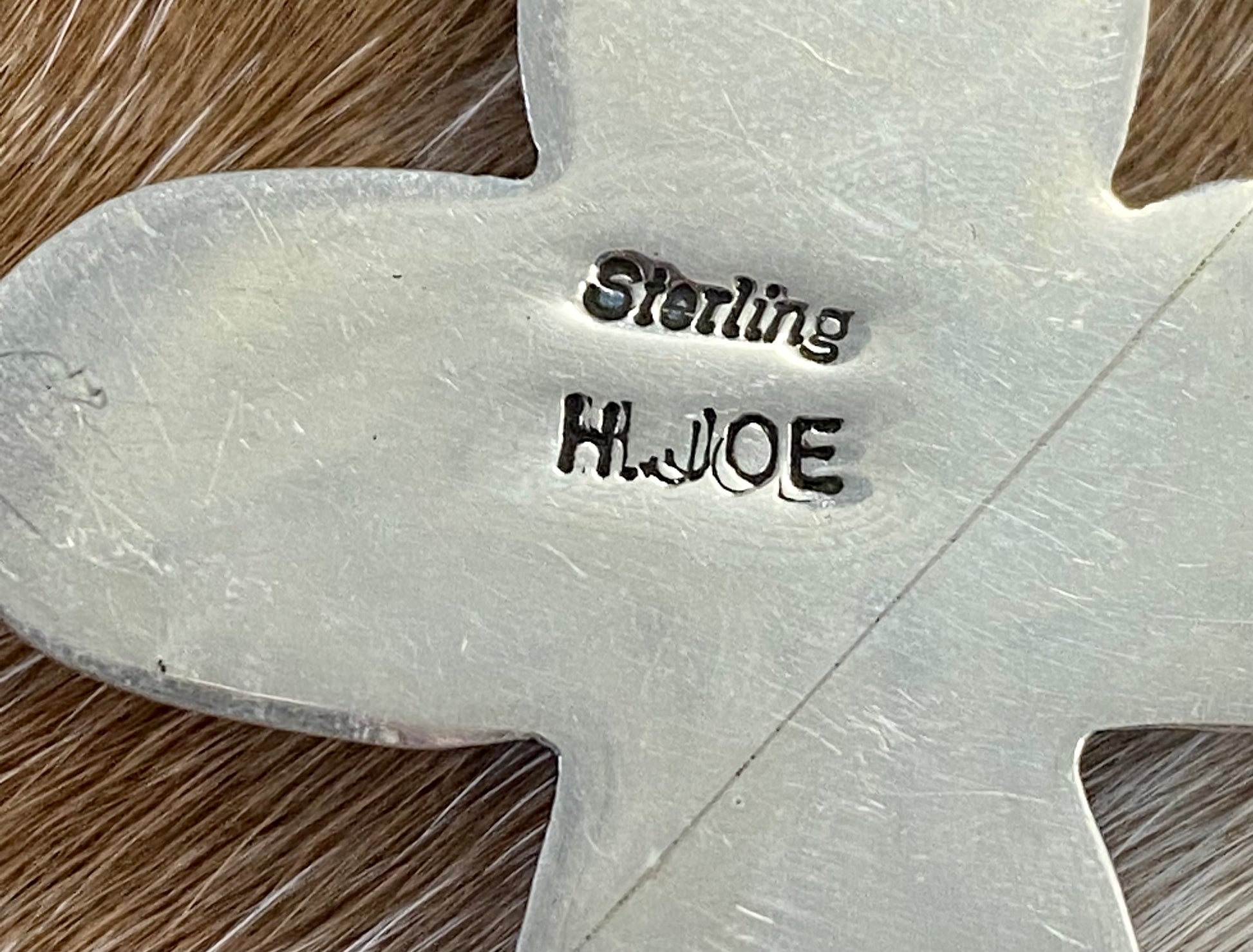 Beautiful sterling silver Native made turquoise cross pendant. Stamped sterling and signed H. JOE by Native American artist silversmith. The perfect cross to wear on any length chain necklace or a 6-7mm Navajo pearl necklace.   Size: 3” Inches length without bale x 2” inches width - bale .5” inch length   Signed: YES "H. JOE"  Hallmark/Artist: H. JOE  Stone: Turquoise