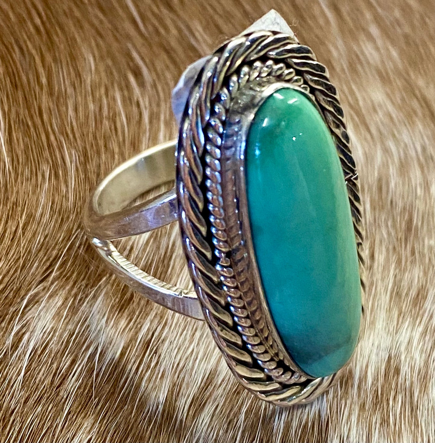 Beautiful simple and elegant Native made sterling silver single stone turquoise ring. Stamped .925 and signed "R.B." inside of a bear icon for Running Bear Shop. The perfect everyday turquoise ring! Size: 1.25” inches length x .5” inch width Ring Size: 7 Signed: YES "R.B." Hallmark/Artist: Running Bear Shop Stone: Turquoise